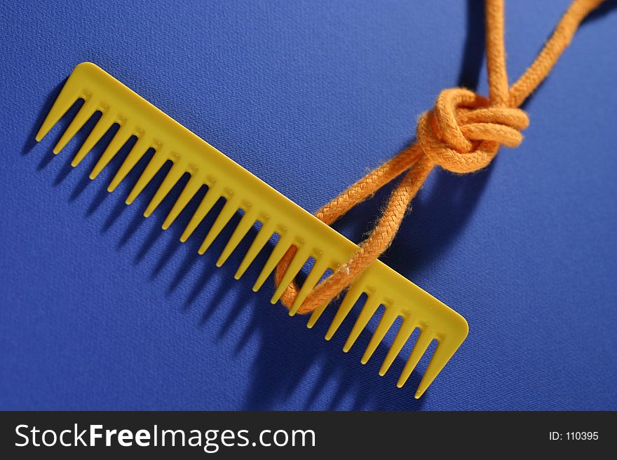 Comb and knot on blue background. Comb and knot on blue background