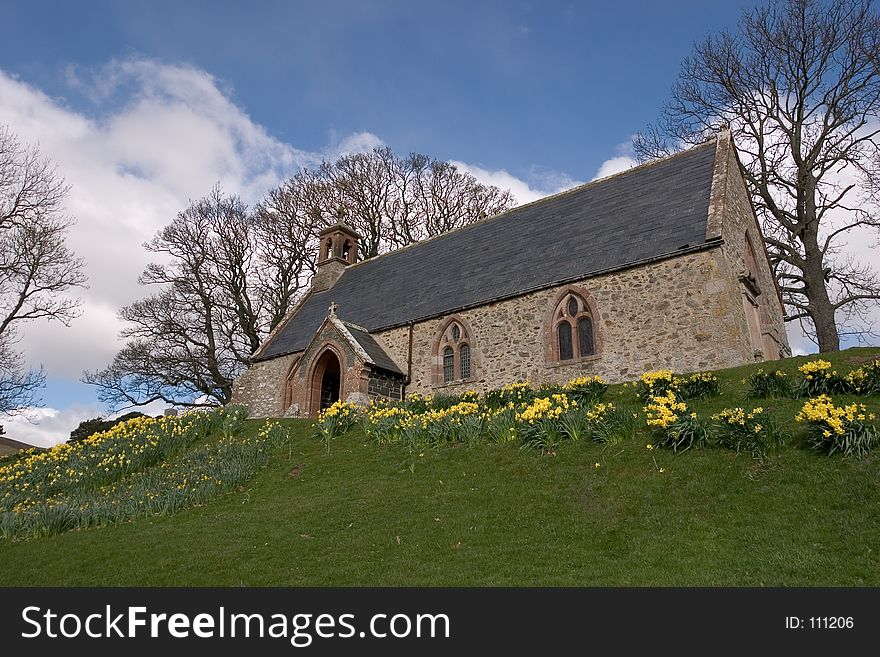 An old Scottish Kirk (church) in springtime with dafodils. An old Scottish Kirk (church) in springtime with dafodils.