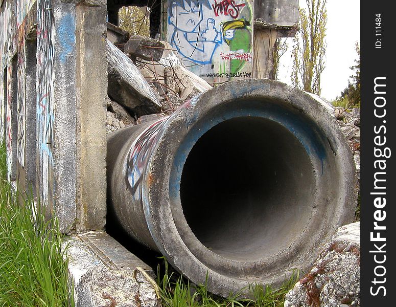 Close-up on a large, concrete pipe and the graffiti surrounding it. Taken at the old Western Washington State Mental Hospital in Steilacoom, WA. Close-up on a large, concrete pipe and the graffiti surrounding it. Taken at the old Western Washington State Mental Hospital in Steilacoom, WA.