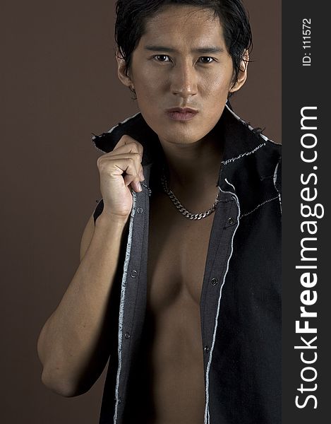 A muscular asian model in a black waistcoat. A muscular asian model in a black waistcoat