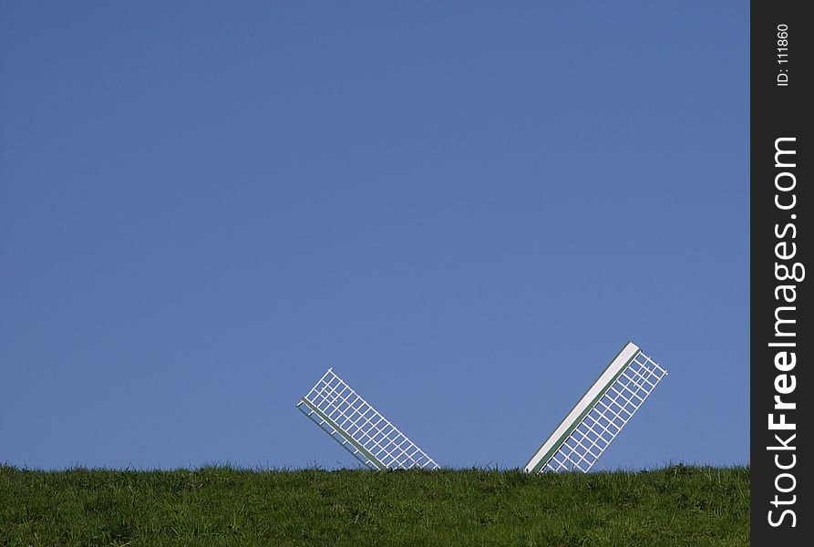 windmill behind a grass hill. windmill behind a grass hill