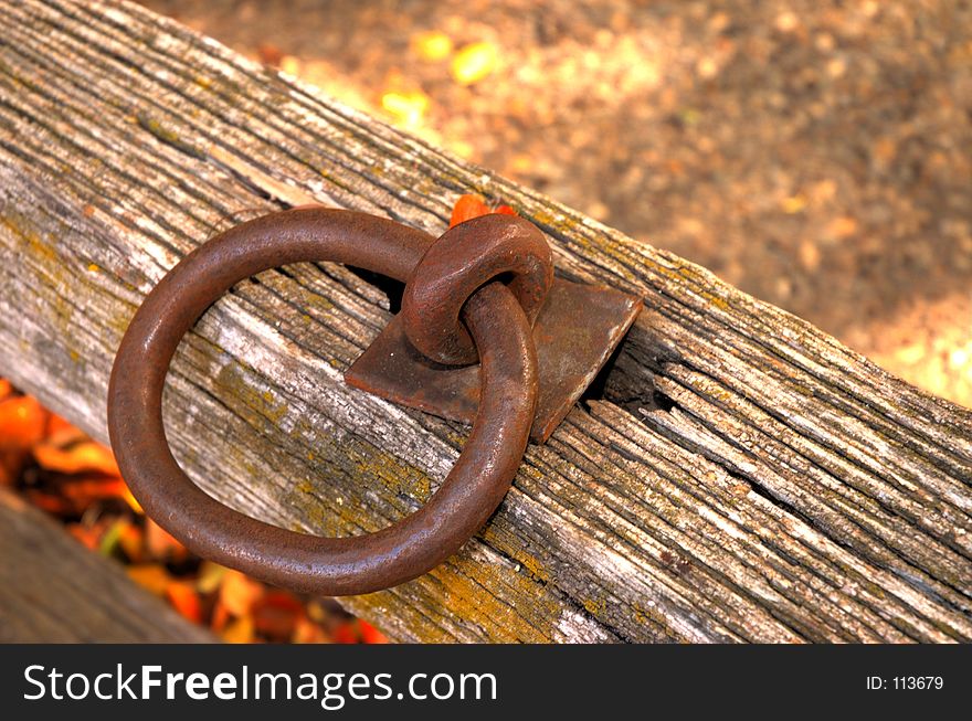 An old iron ring on rotting wood