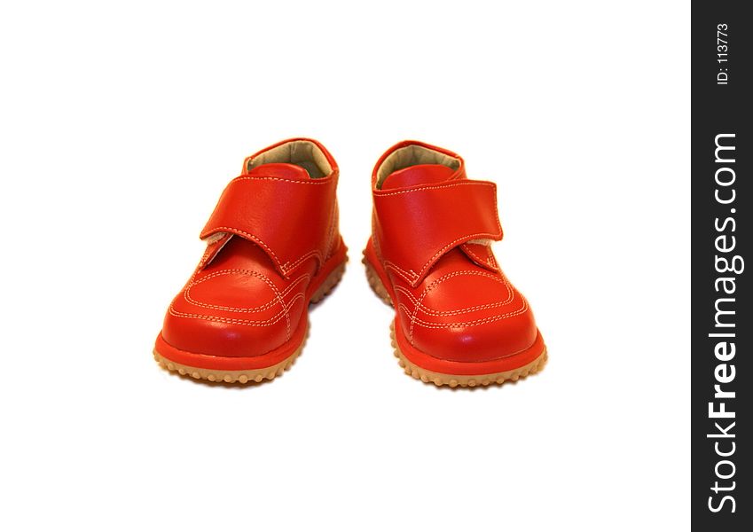 A pair of shiny red baby shoes - front