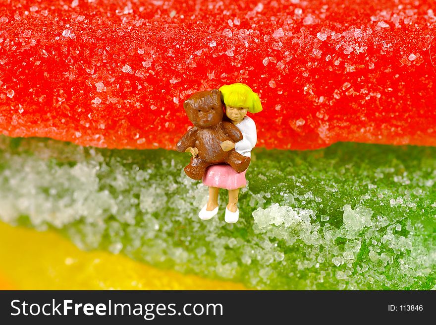 Miniature Child Sitting on Jelly Candy