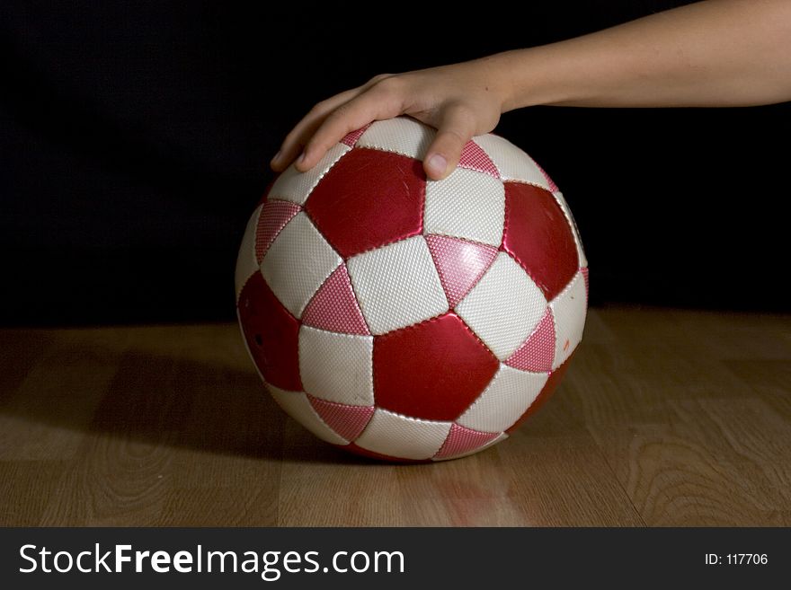 Hand palming a soccer ball. Hand palming a soccer ball