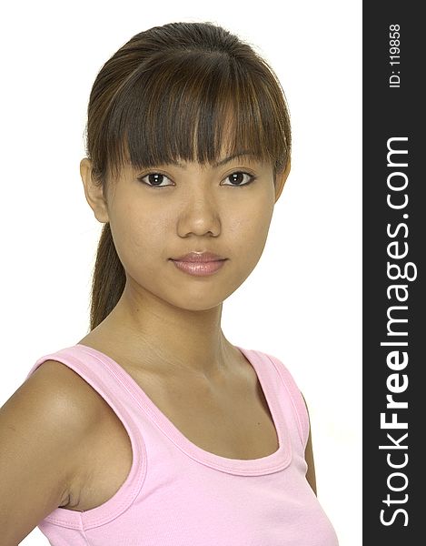 A cute young asian girl in a pink top and a hint of a smile. A cute young asian girl in a pink top and a hint of a smile