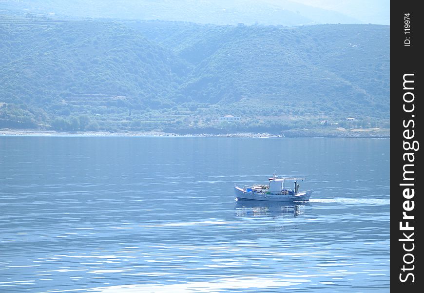 A fisherman coming back from early-morning fishing in the seas of Neapoli Lakonias, Greece. A fisherman coming back from early-morning fishing in the seas of Neapoli Lakonias, Greece