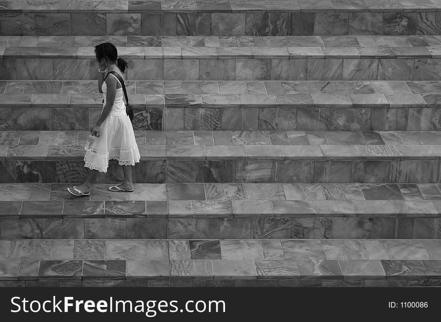 Black and white photo of walking girl