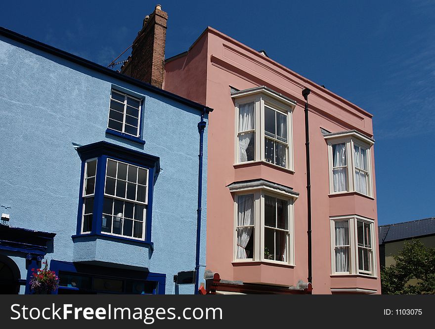 A pink and a blue house sitting next to each other in the lovely seaside town of Tenby in the county of Pembrokeshire in Wales. A pink and a blue house sitting next to each other in the lovely seaside town of Tenby in the county of Pembrokeshire in Wales.