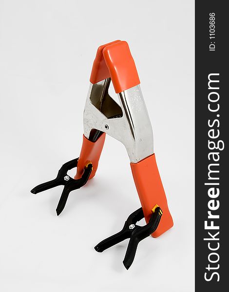 Orange clamp being attacked by two small black clamps. Orange clamp being attacked by two small black clamps.