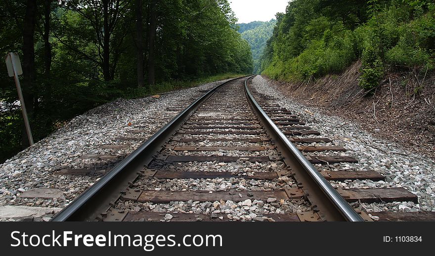 Railroad track curving into distance, low angle. Railroad track curving into distance, low angle