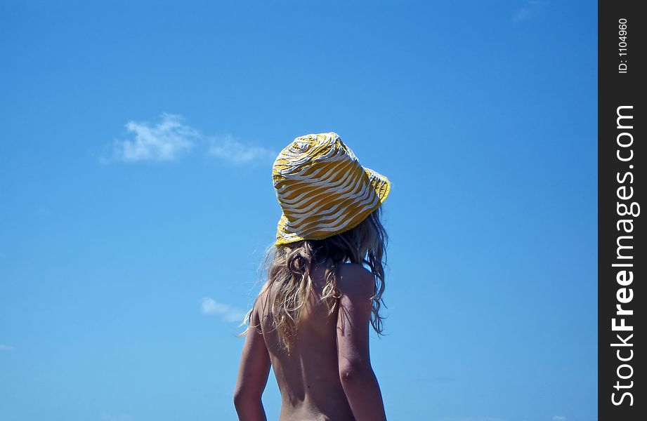 Young girl with blue sky behind