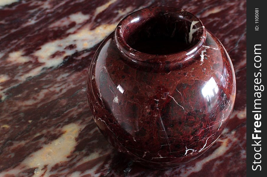 Ox red marble vase on ox red marble background