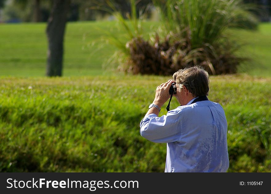 Bird Watcher looking at the birds on the Golf Course