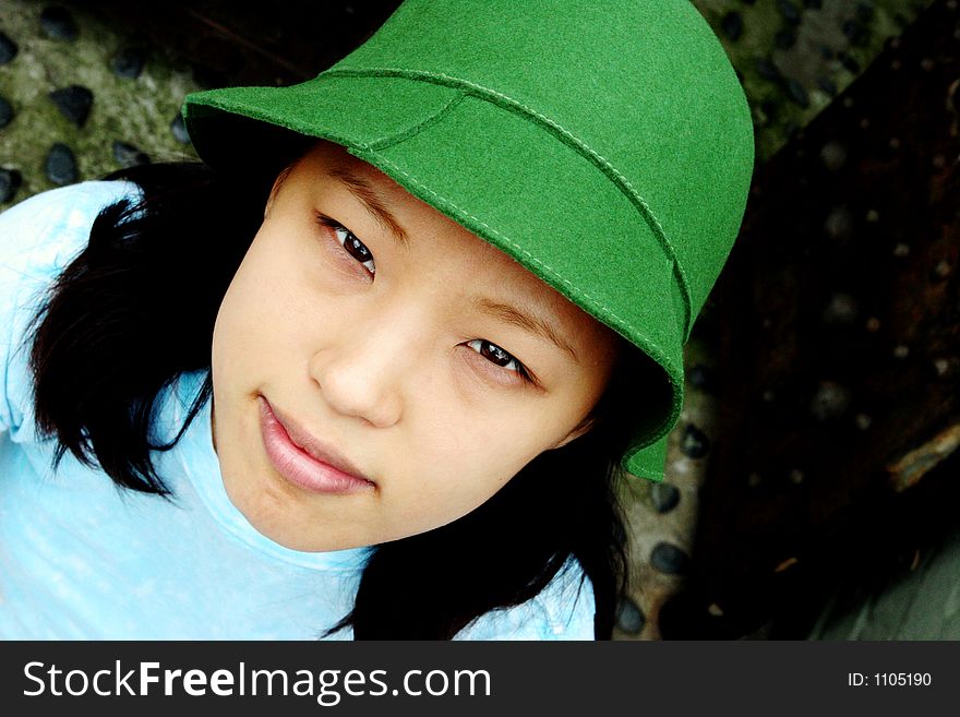 Fresh faced young Korean woman wearing a green hat. Fresh faced young Korean woman wearing a green hat