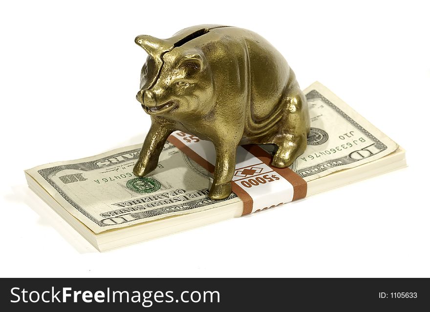 Brass Piggy Bank on a Stack of Money. Brass Piggy Bank on a Stack of Money