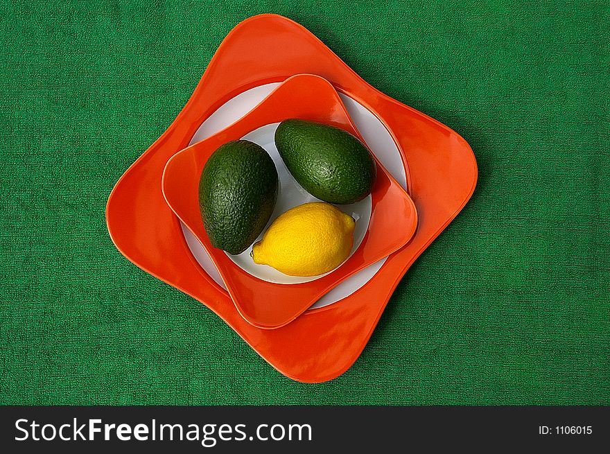 Lemon and avocado on plate