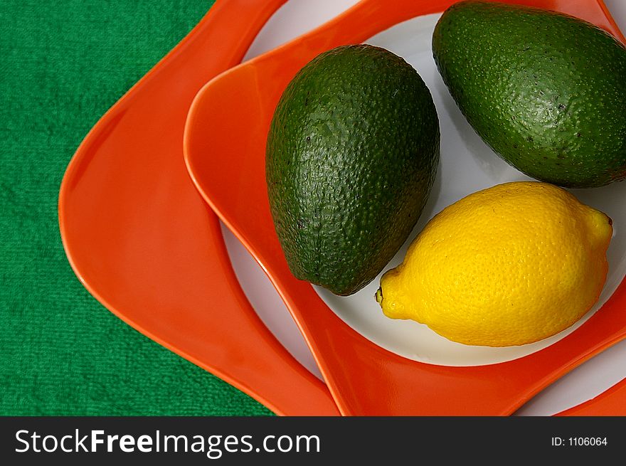 Lemon and avocado on plate