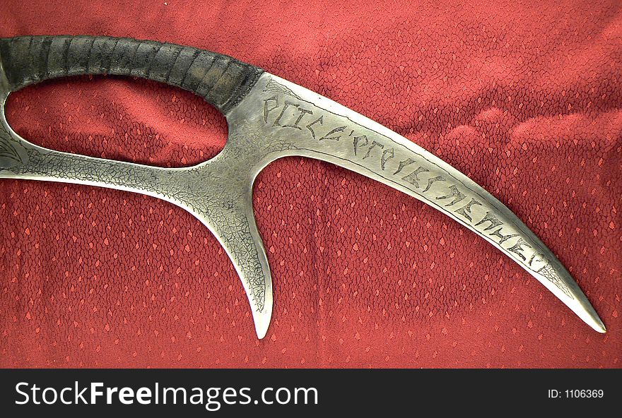 Part of a Klingon style weapon on velvet with letters. Part of a Klingon style weapon on velvet with letters.