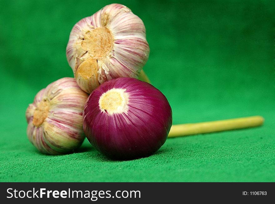 Garlic and red onion on green. Garlic and red onion on green