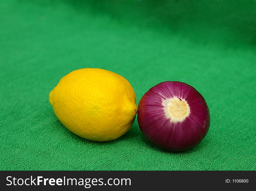 Lemon and red onion on green. Lemon and red onion on green