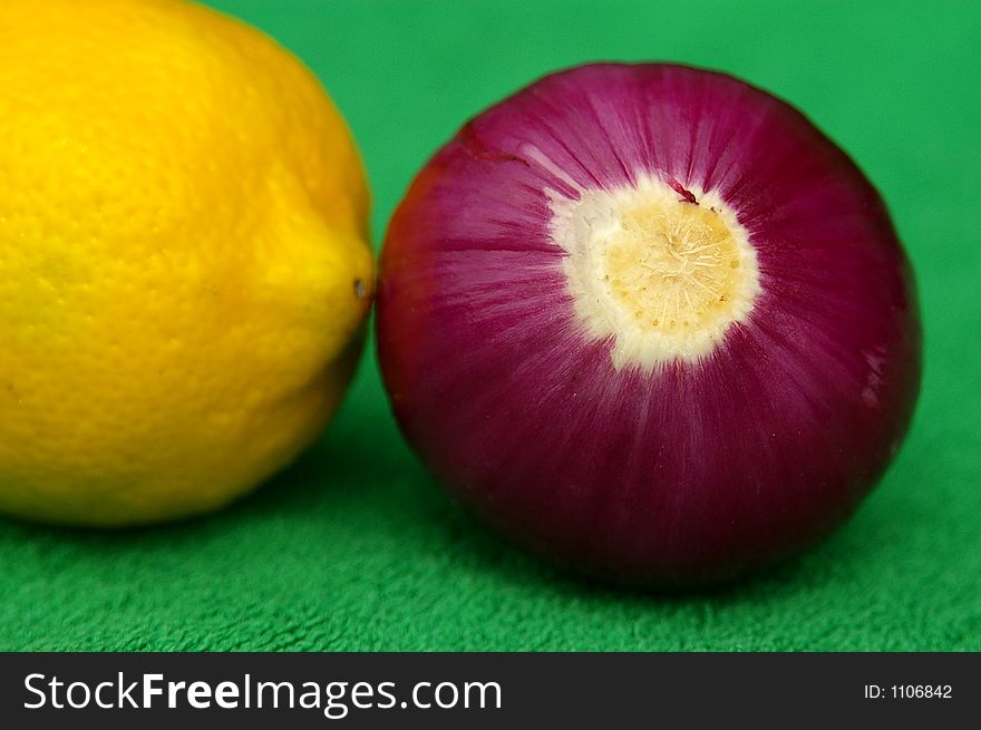 Big lemon and red onion on green. Big lemon and red onion on green