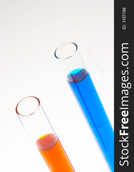 Two test tubes one with red and one with blue liquid filled on white background. Two test tubes one with red and one with blue liquid filled on white background