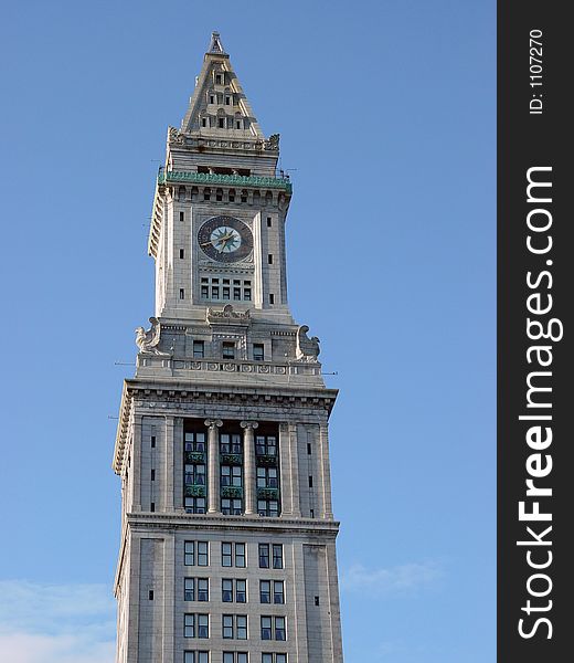 Clock tower in downtown boston against blue, sky, early morning. Clock tower in downtown boston against blue, sky, early morning