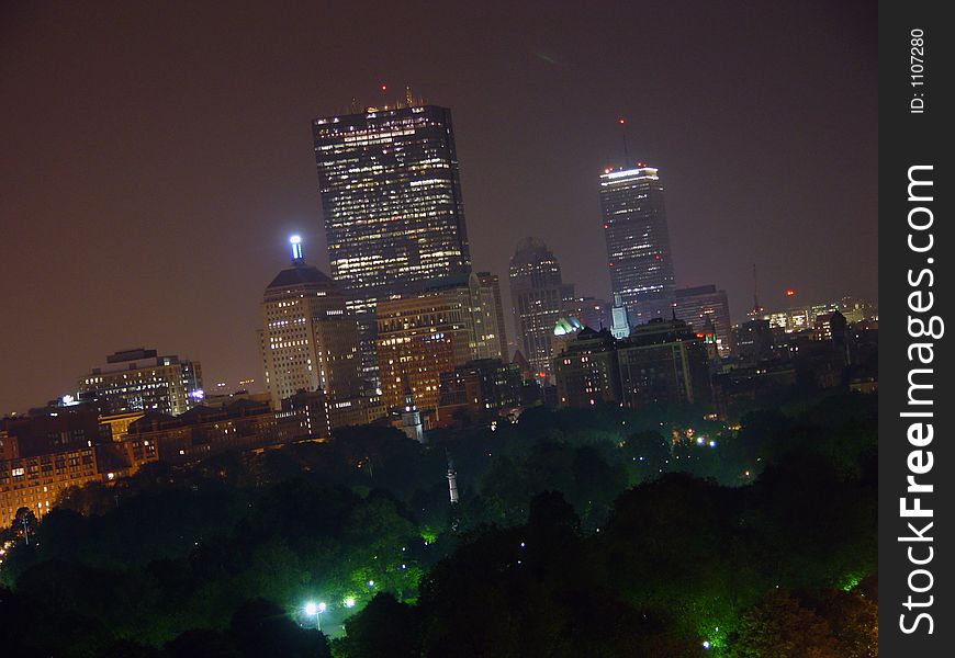 Night shot of the boston skyline, from park street to the prudential center. the trees along the bottom are the boston common. Night shot of the boston skyline, from park street to the prudential center. the trees along the bottom are the boston common