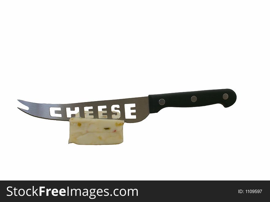 A chunk of white cheese with a cheese knife stuck in it against a white background