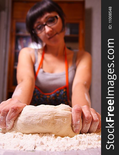 Nice woman kneads a dough. Nice woman kneads a dough