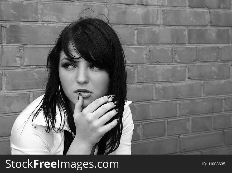 Beautiful woman smokes a cigarette. black-and-white image. Beautiful woman smokes a cigarette. black-and-white image