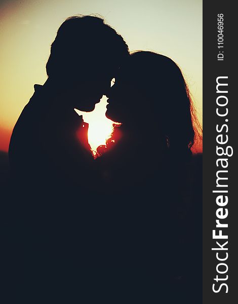 Silhouette Photo of Man and Woman About to Kiss