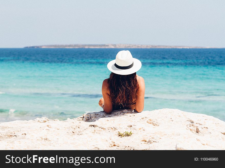 Woman Lying on White Sand Beach