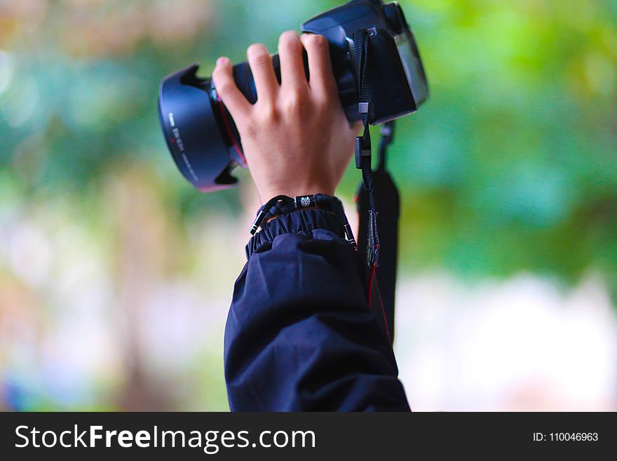 Person Holding Black Dslr Camera