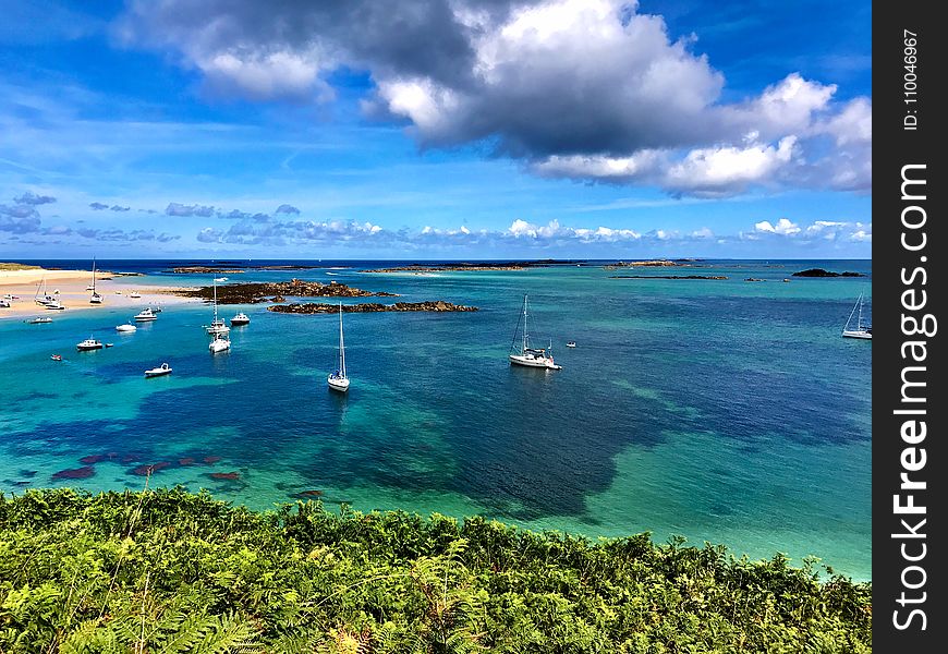 High Angle Photography of Beach With Sailing Boats Under Blue Sky and Gray Clouds