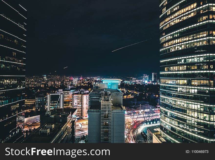 High Rise City Building During Night Time Photo