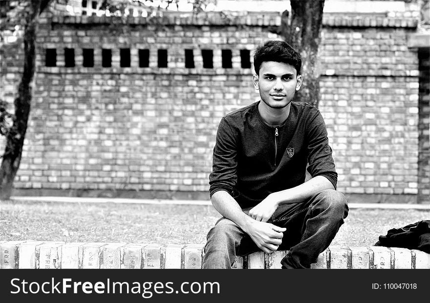 Grayscale Photography of Man in Front of Wall
