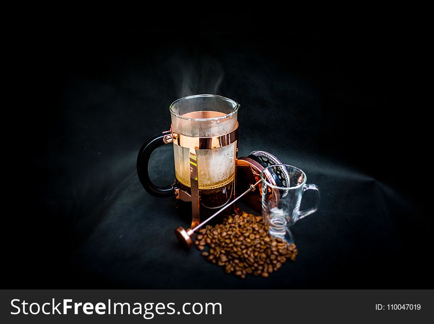 Photo of Open Coffee Press Beside Glass