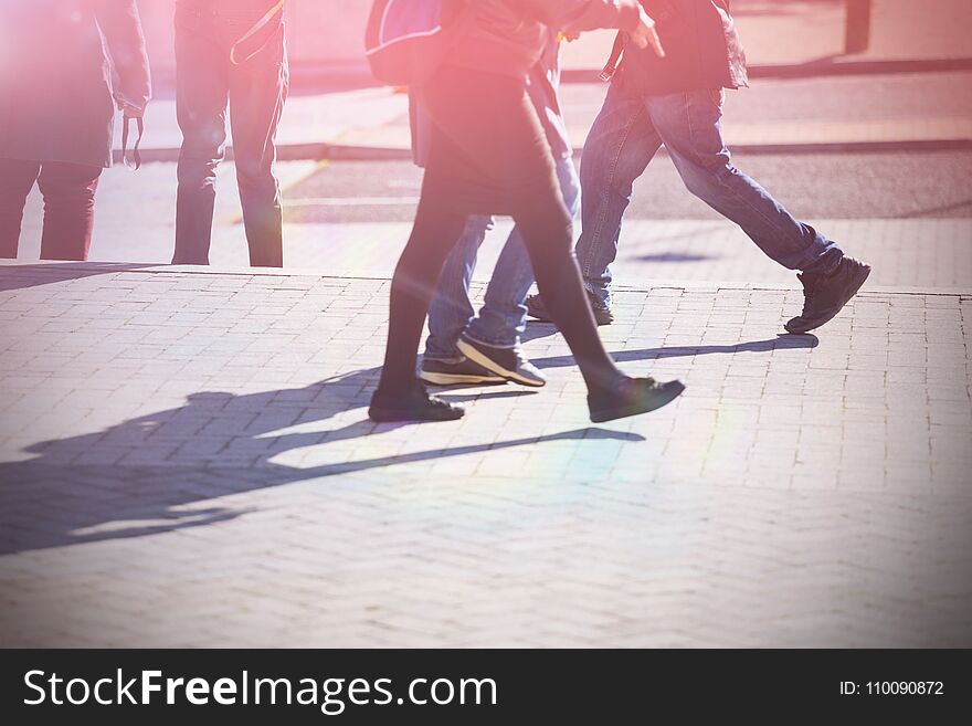 Low section of people walking on sidewalk in city