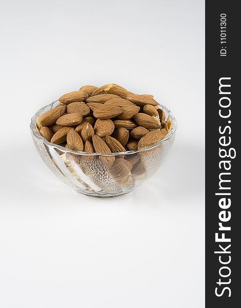 Big Almonds in a glass bowl on white background