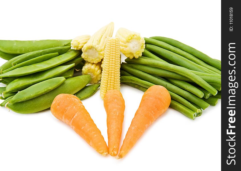 Healthy cooking with fresh vegetables - baby corn, beans and carrots. Isolated on white background. Healthy cooking with fresh vegetables - baby corn, beans and carrots. Isolated on white background.