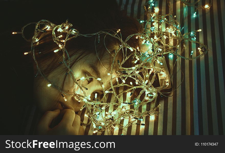 Woman Near Assorted-color String Lights