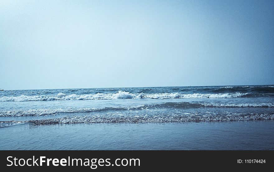 Calm Water On Seashore At Daytime