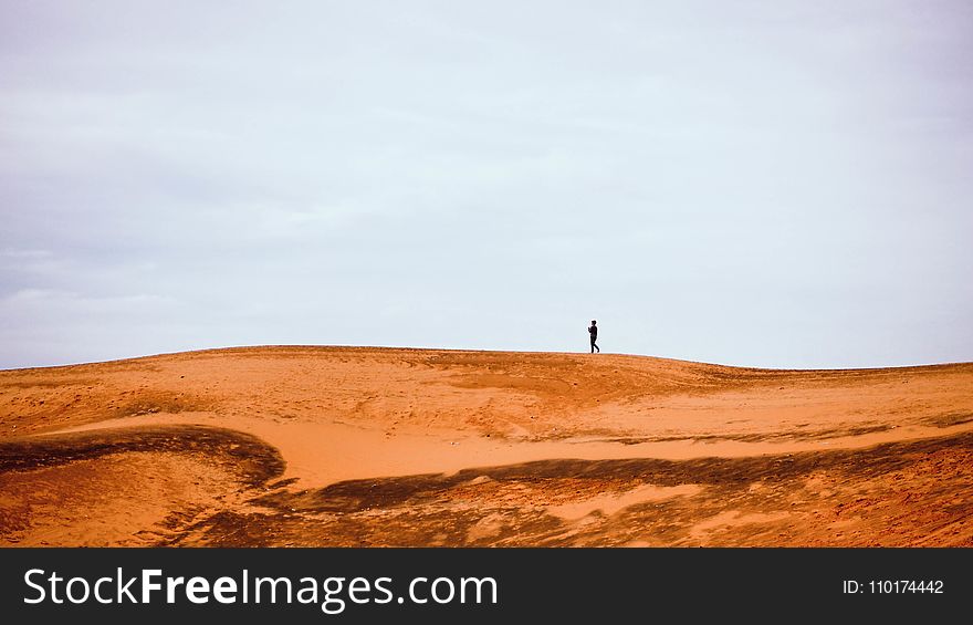 Man Standing On A Dessert Graphic Wallpaper