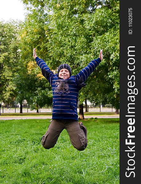 Portrait of a smiling teenager jumping in the park. Portrait of a smiling teenager jumping in the park