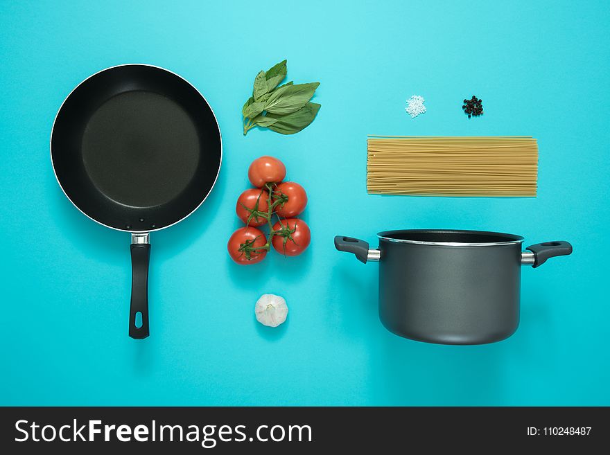 Black and Gray Cooking Pot and Frying Pan With Tomatoes
