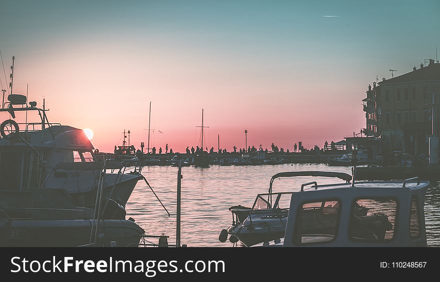 White Yacht On Body Of Water During Sunset