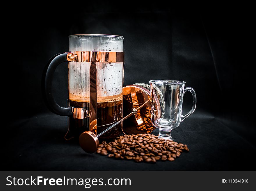 Coffee Beans Beside Coffee Press and Glass Cup