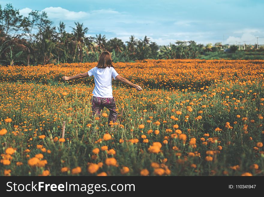 Girl Running on Yellow Flowers